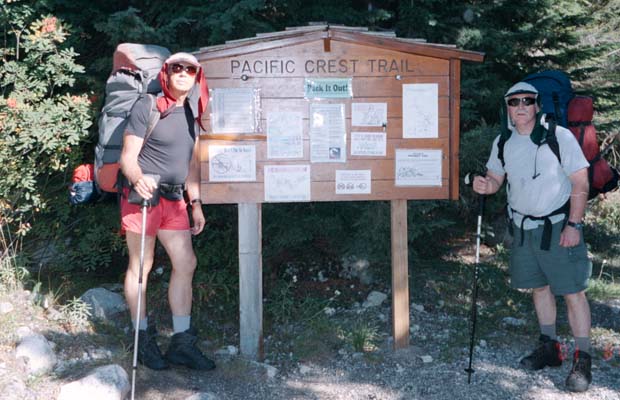 Peter and Pat holding up the signboard at White Chuck trailhead