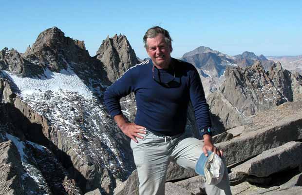 Jim on summit of Mt Sill with North Palisade and Thunderbolt peaks behind
