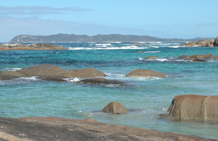 The sheltered pools behind the rocks in William Bay National Park. Parry Head in the distance