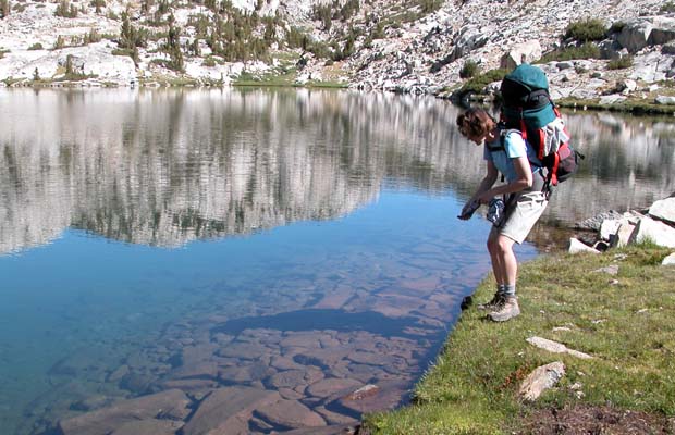 Lucy admiring the crystal clear waters of Heart Lake, below Selden Pass