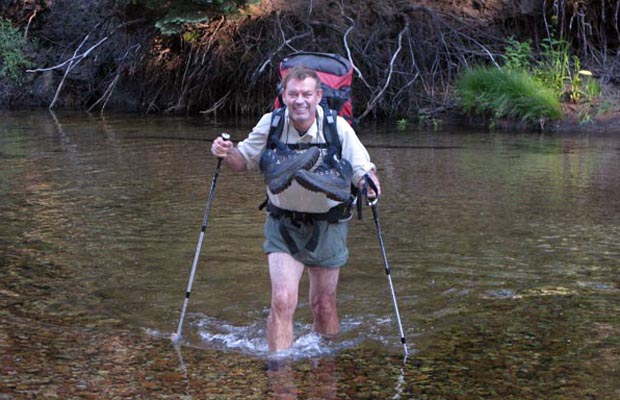 Jim K. wading Stubblefield Creek in the early morning after breaking camp.