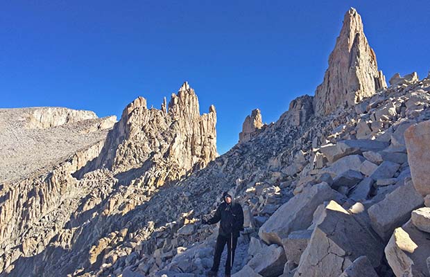 Peter negotiating the narrow trail below the Keeler Needles. Whitney summit on the upper left.