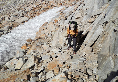 Bob descending from Feather Pass to cross a small snow-bank.