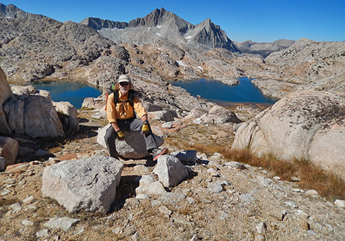 Bob relaxing after our climb.  Ursa and Big Bear Lakes below.