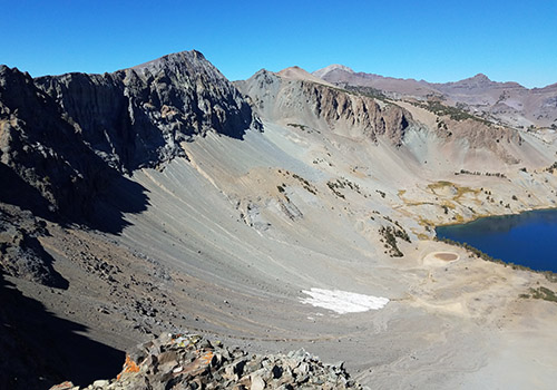 The PCT to Sonora Pass runs along the back of the vertical rockface.