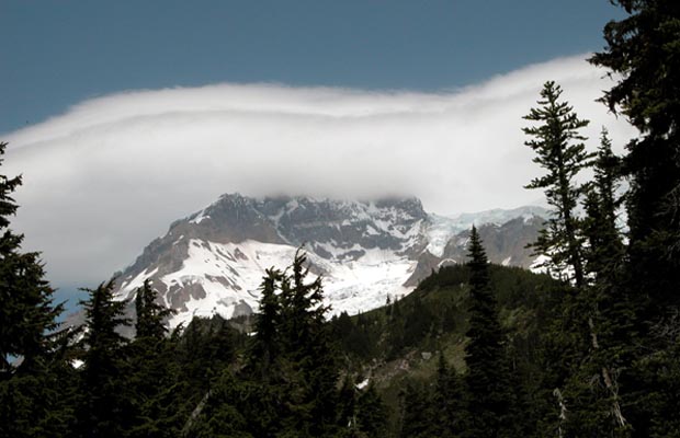 A lenticular cloud enveloping Sunset Ridge on the northwest face of Mt. Rainier